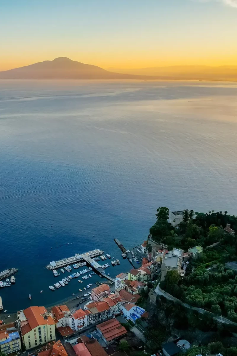 Tramonto sul Golfo di Napoli con vista sul Vesuvio e sulla costa.